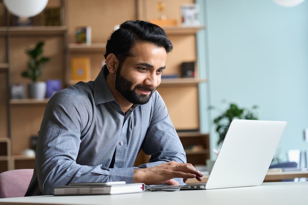 happy-man-looking-at-laptop